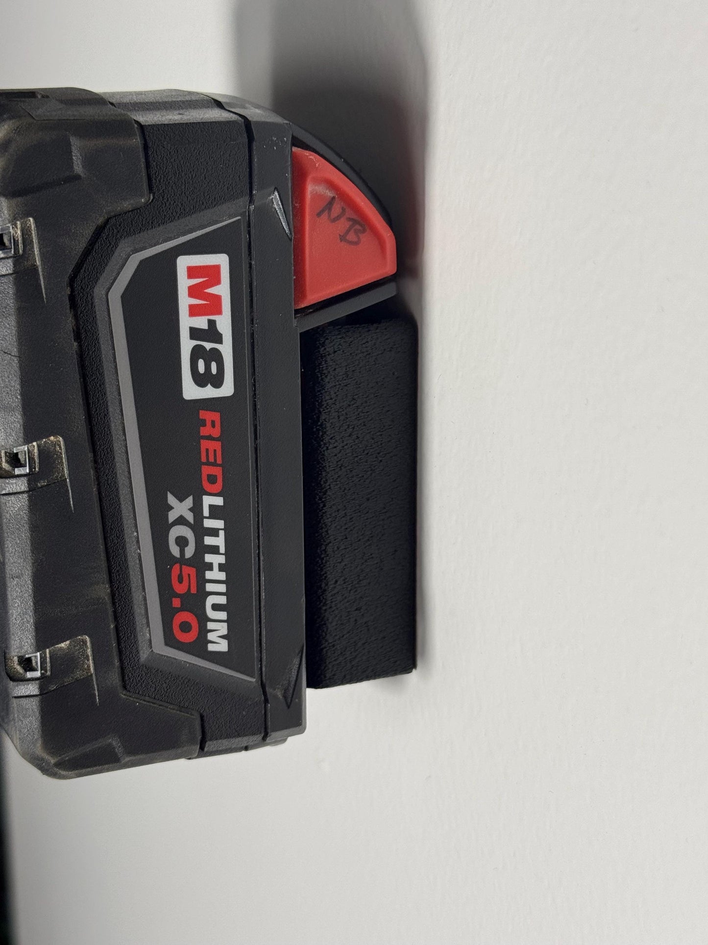 Side view of M18 battery holder showing fit and thickness