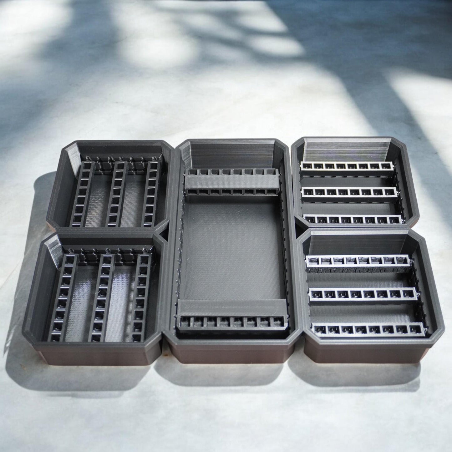 Bit Bins designed for use with the Milwaukee Low-Profile Compact Small Parts Organizer. Made from durable PETG, this set includes all holders shown in the images: four small square bins and one long rectangular bin.