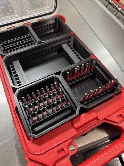 Bit Bins designed for use with the Milwaukee Low-Profile Compact Small Parts Organizer. Made from durable PETG, this set includes all holders shown in the images: four small square bins and one long rectangular bin.
