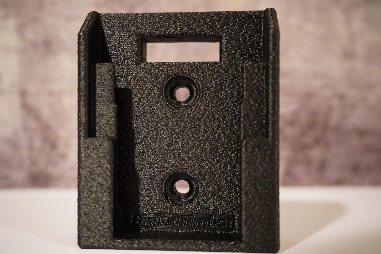 Close-up of DeWalt 20V battery holder with DigitalTimber logo on a textured background