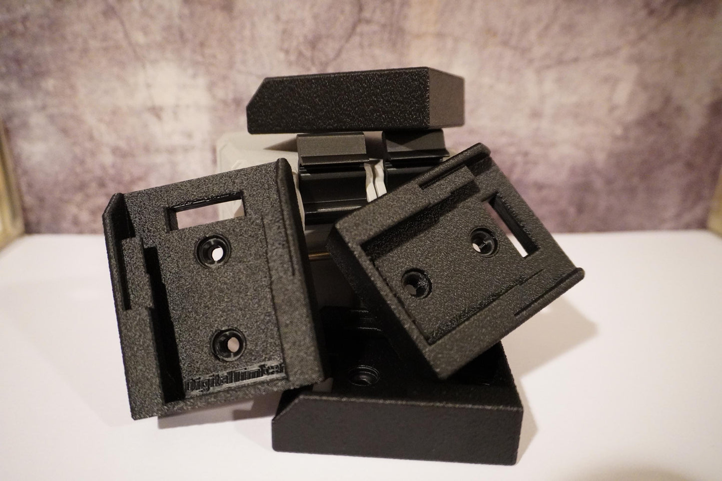Multiple 3D printed DeWalt battery holders stacked with mounting slots shown