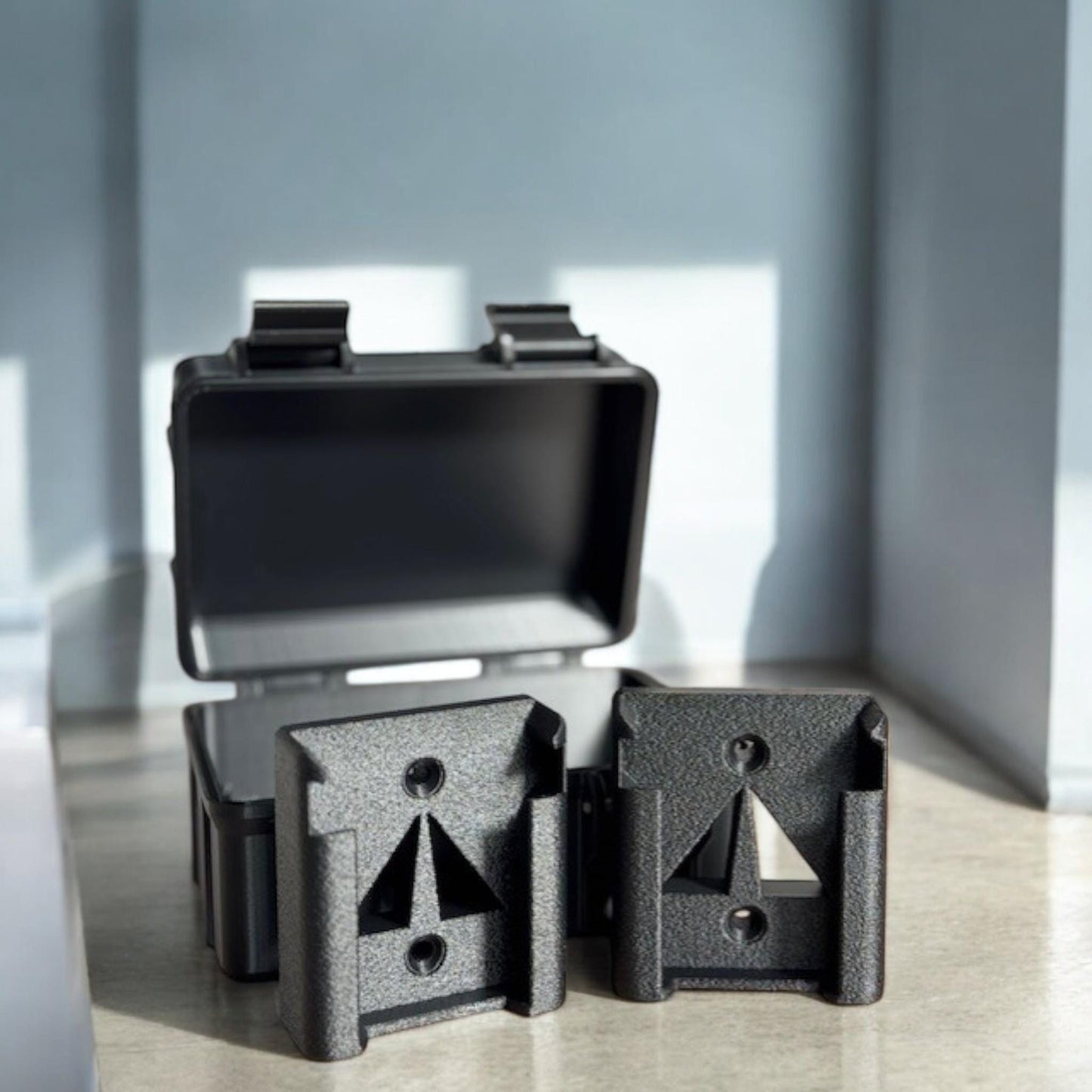 wo M18 battery holders shown next to a case for scale