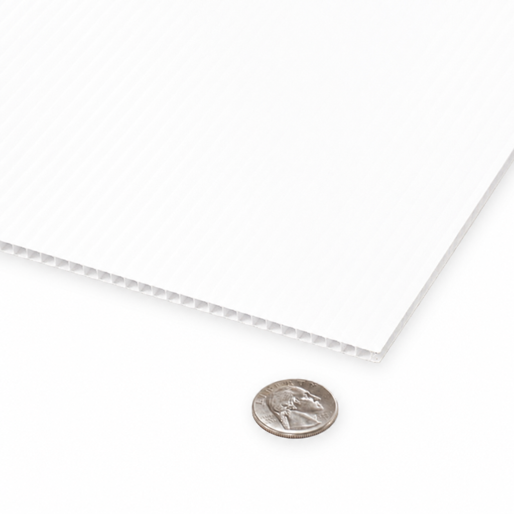 A close-up of a white textured sheet with a ribbed corrugated edge, shown on a white background with a US quarter coin for scale.