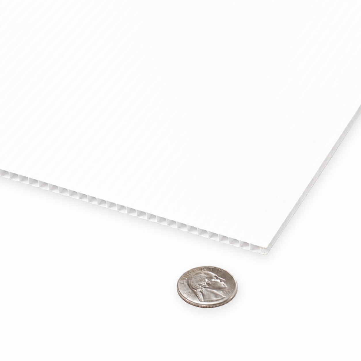 A close-up of a white textured sheet with a ribbed corrugated edge, shown on a white background with a US quarter coin for scale.