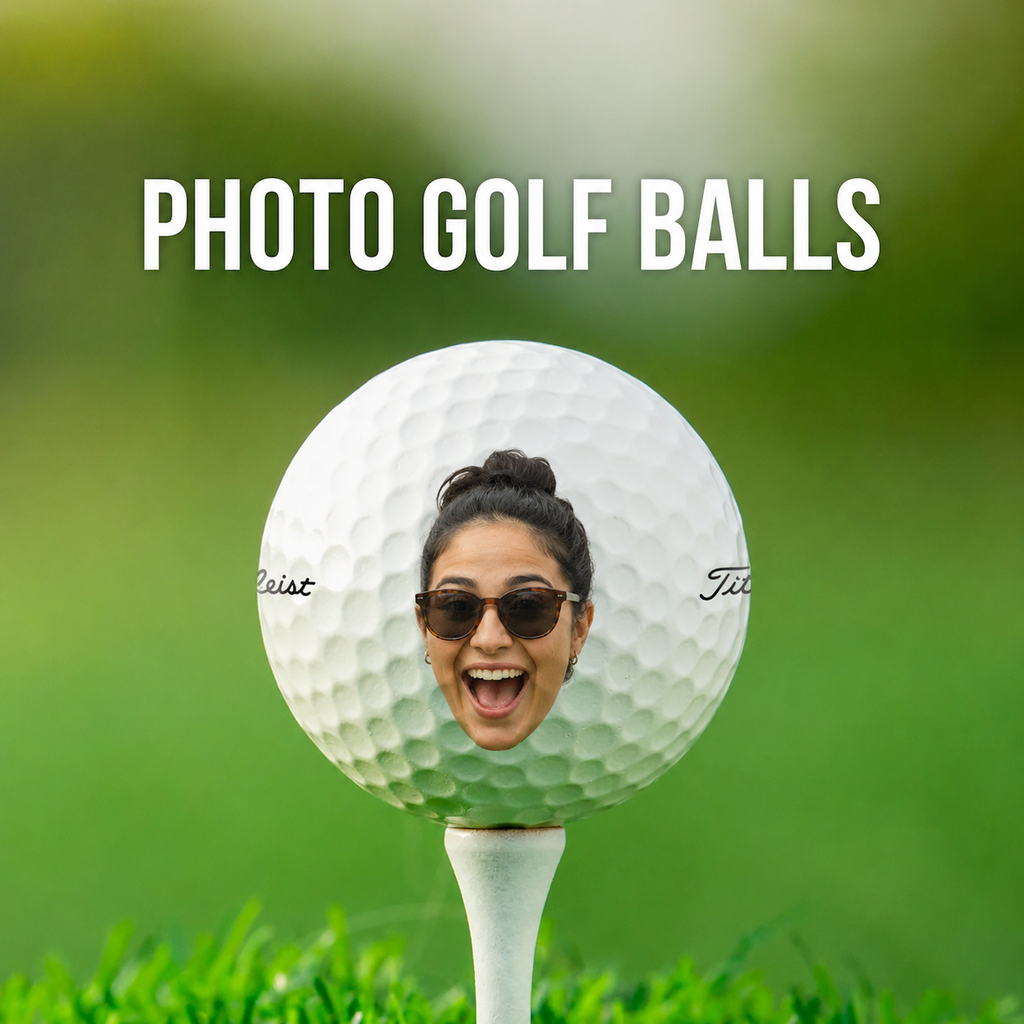 A white golf ball on a white tee with a woman's face peeking out behind it, set against a blurred green golf course background. Large white text at the top reads 'PHOTO GOLF BALLS'.