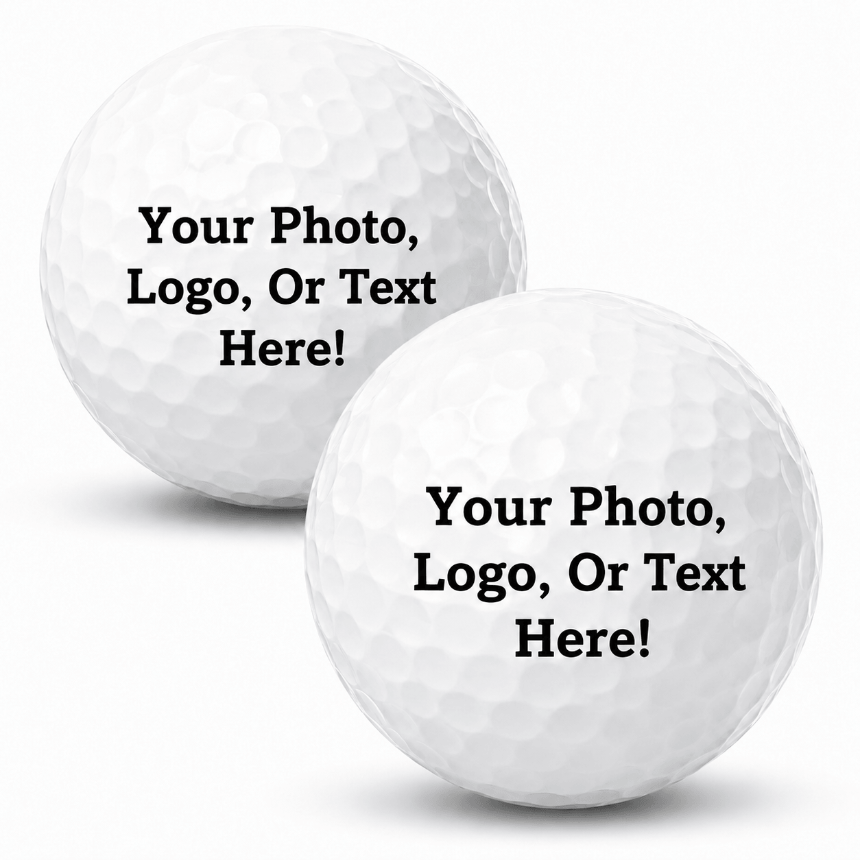 Two white golf balls on a light gray background, each printed with the placeholder text 'Your Photo, Logo, Or Text Here!