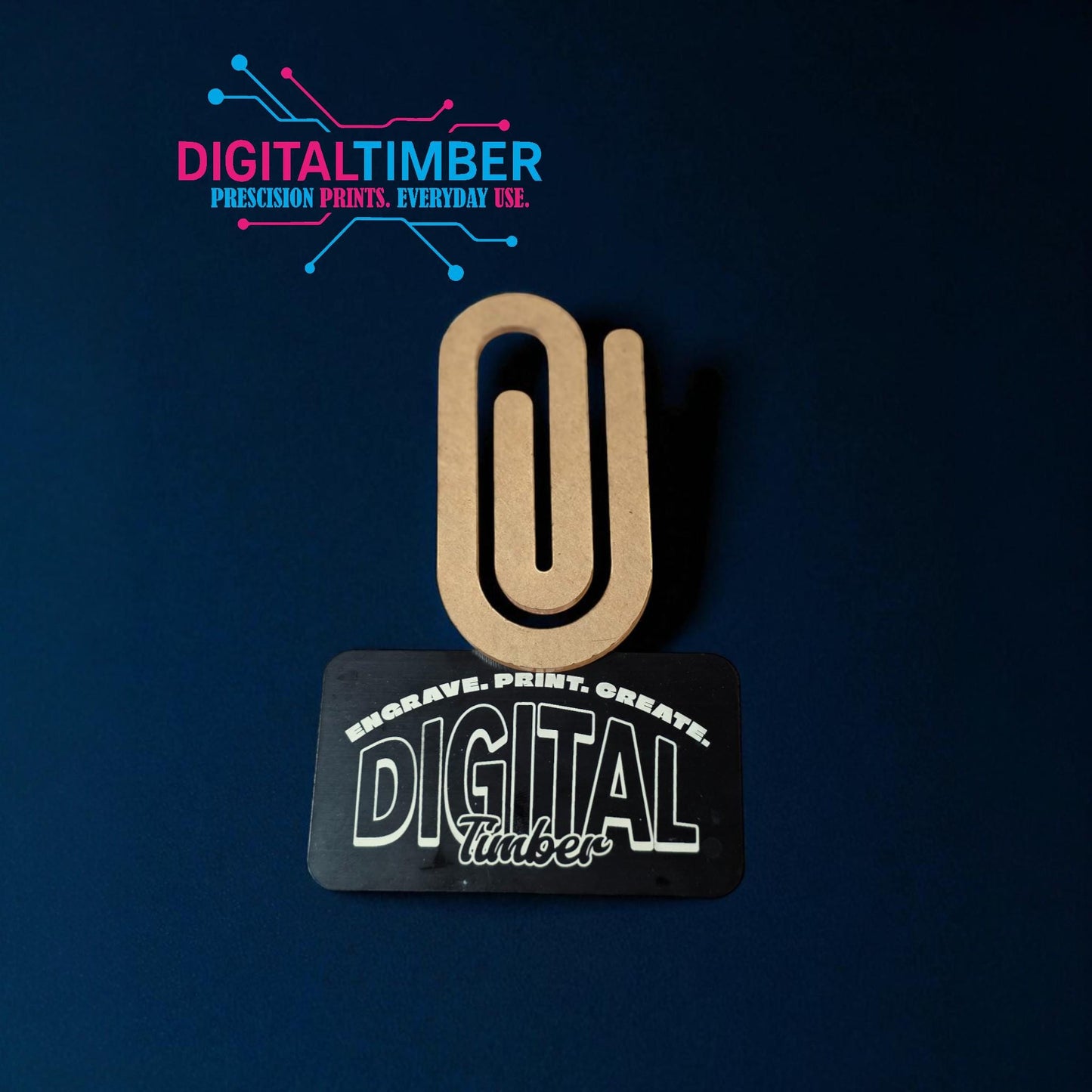 Single jumbo acrylic paper clip leaning on a DigitalTimber card, showing shape and thickness clearly