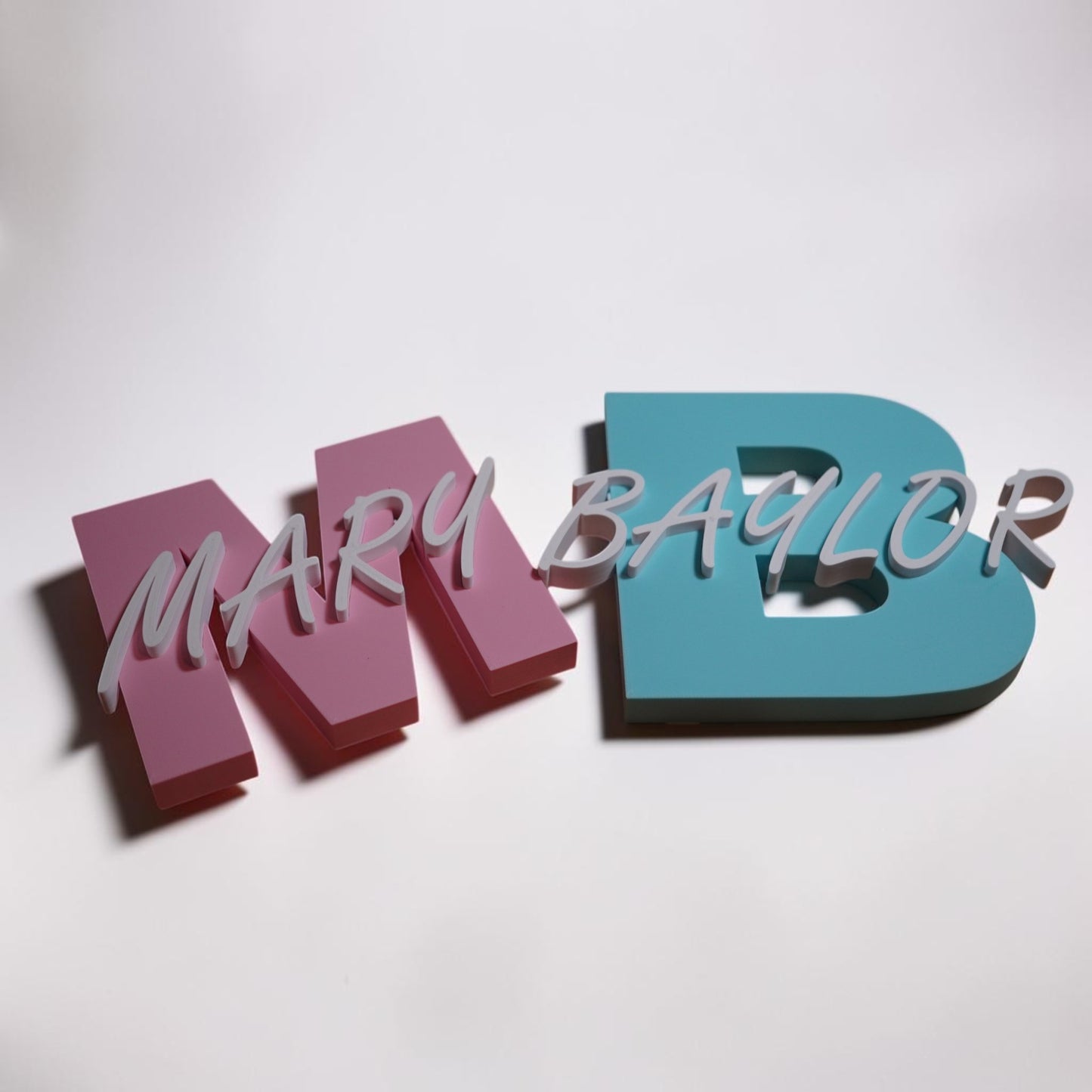 Colorful 3D letters spelling 'MARY BAYLOR' on a white background