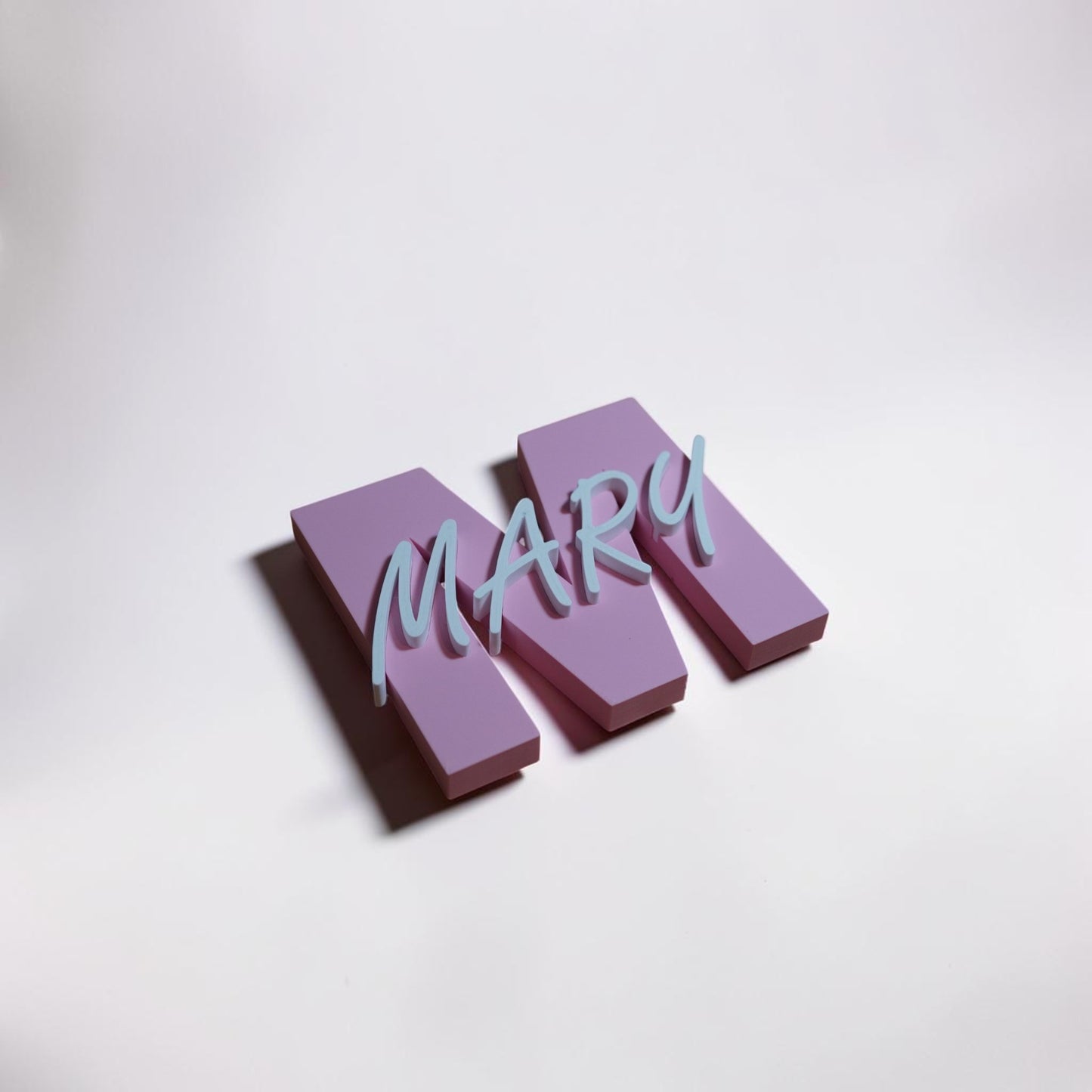 Three-dimensional letters spelling 'MARY' on a light gray background