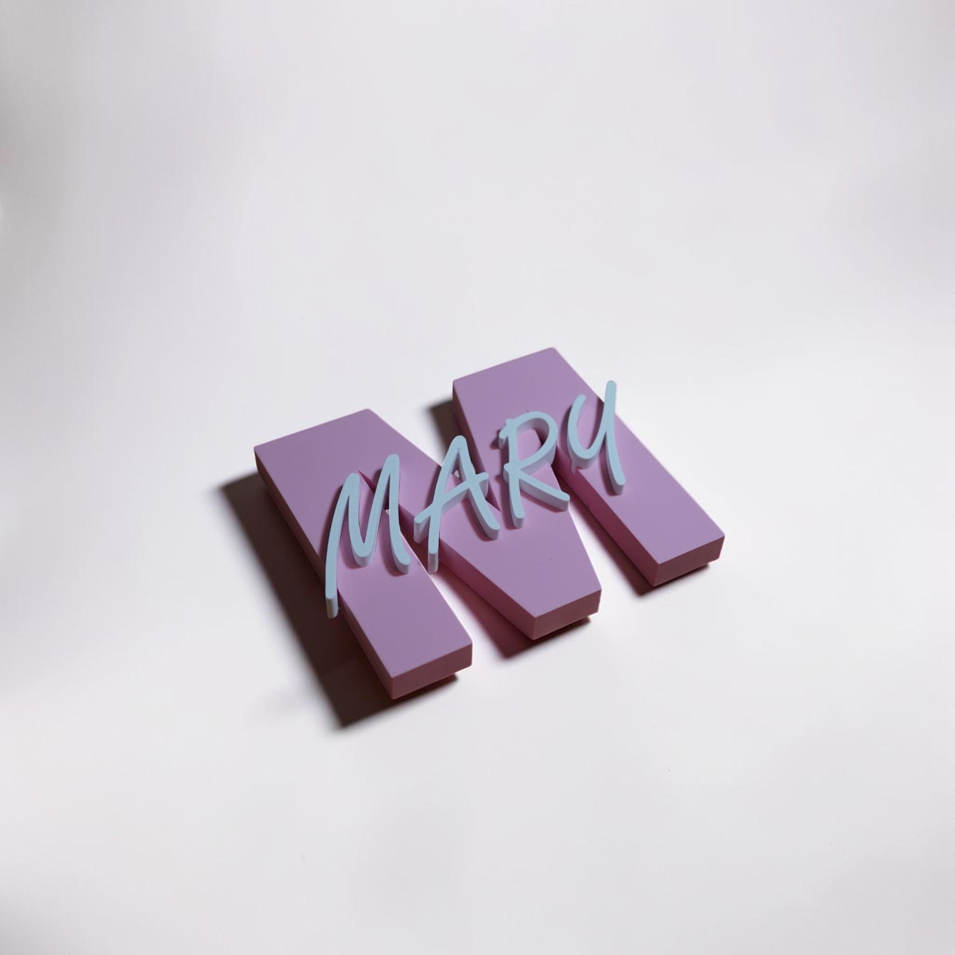 Three-dimensional letters spelling 'MARY' on a light gray background