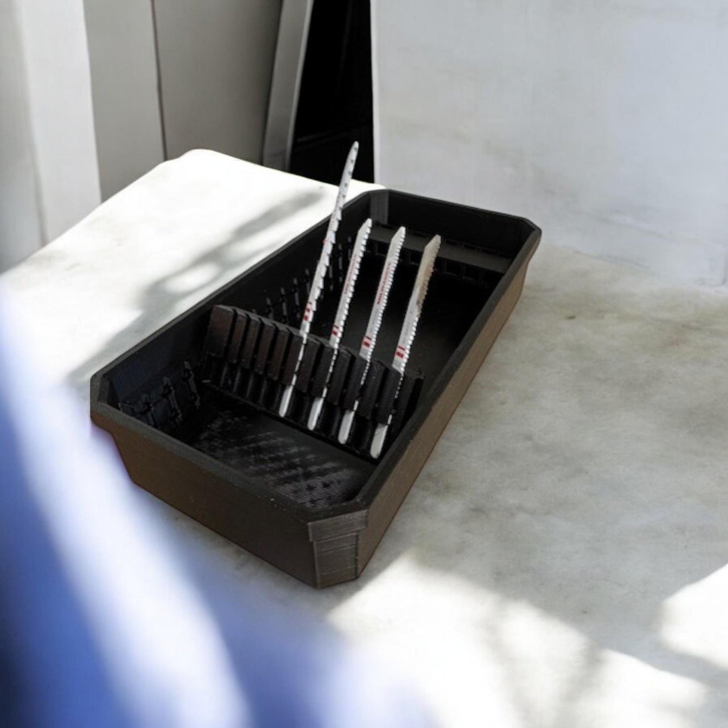 Set of two 3D-printed Milwaukee Packout jigsaw blade holders with blades snapped in for secure storage and transport.