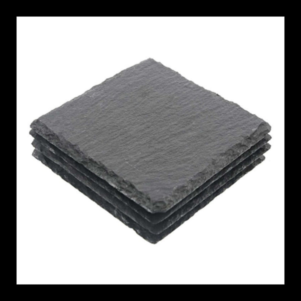 Set of four blank black square slate coasters stacked together with natural rough edges.