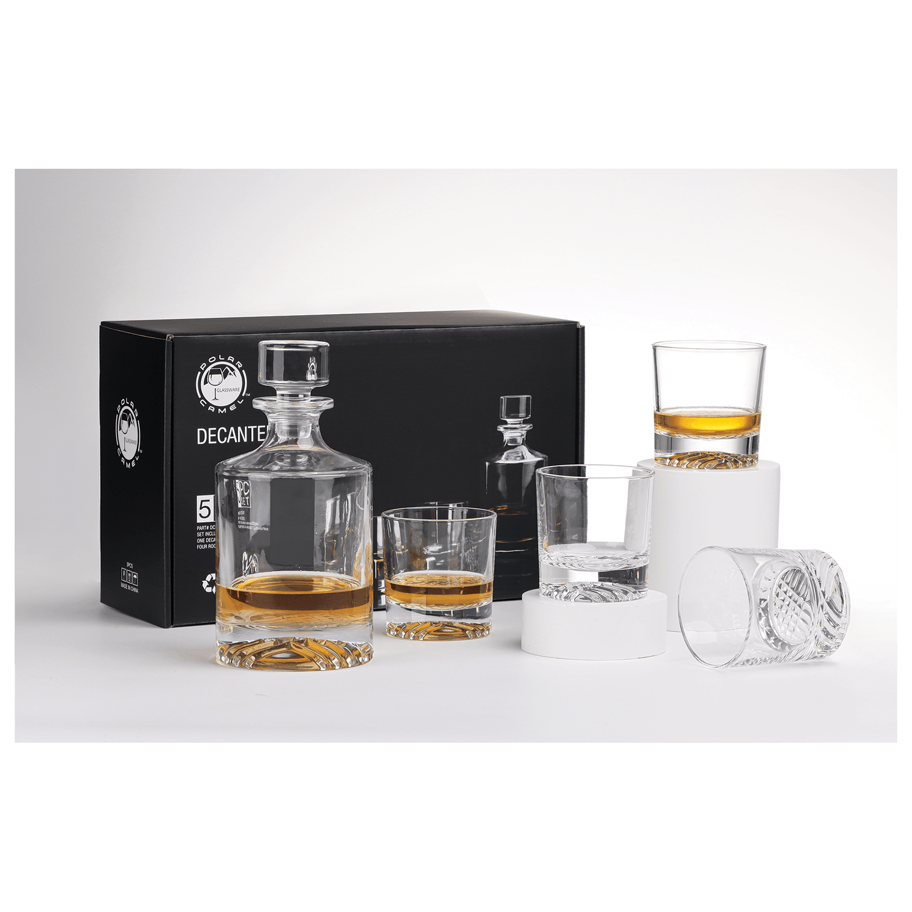Whiskey decanter set with glasses on a white surface