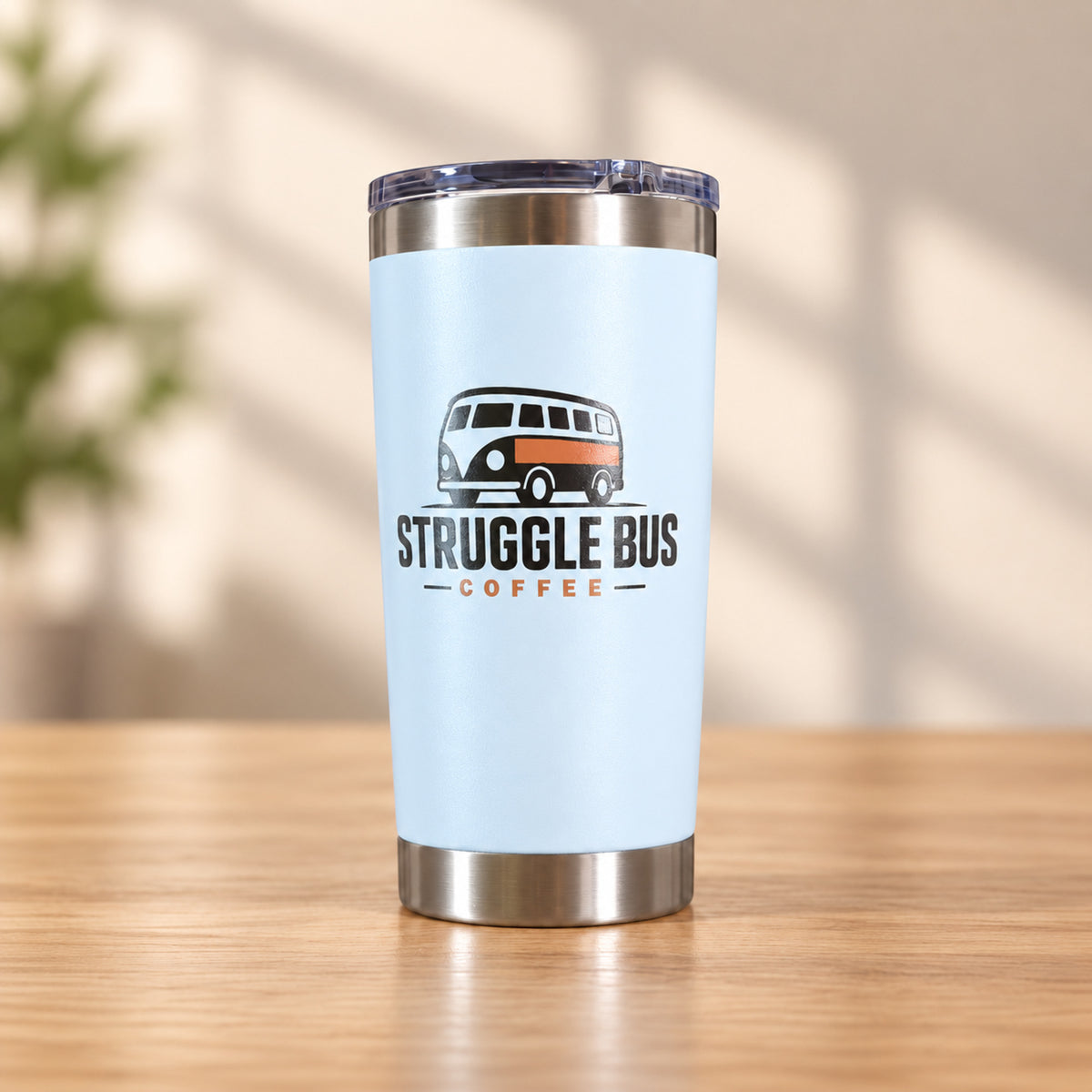 Light blue stainless steel tumbler printed with the Struggle Bus Coffee logo