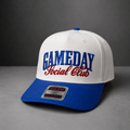 A white and royal blue snapback cap with 'GAMEDAY Social Club' embroidered on the front, photographed on a gray studio background.
