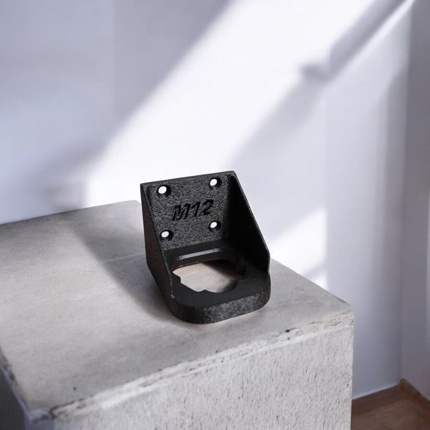 Wall-mounted M12 battery holder made from PETG, featuring multiple slots for securely storing M12 batteries. The holder is mounted on a wall, showcasing its compact and organized design. (etsy image id: 6528013654)