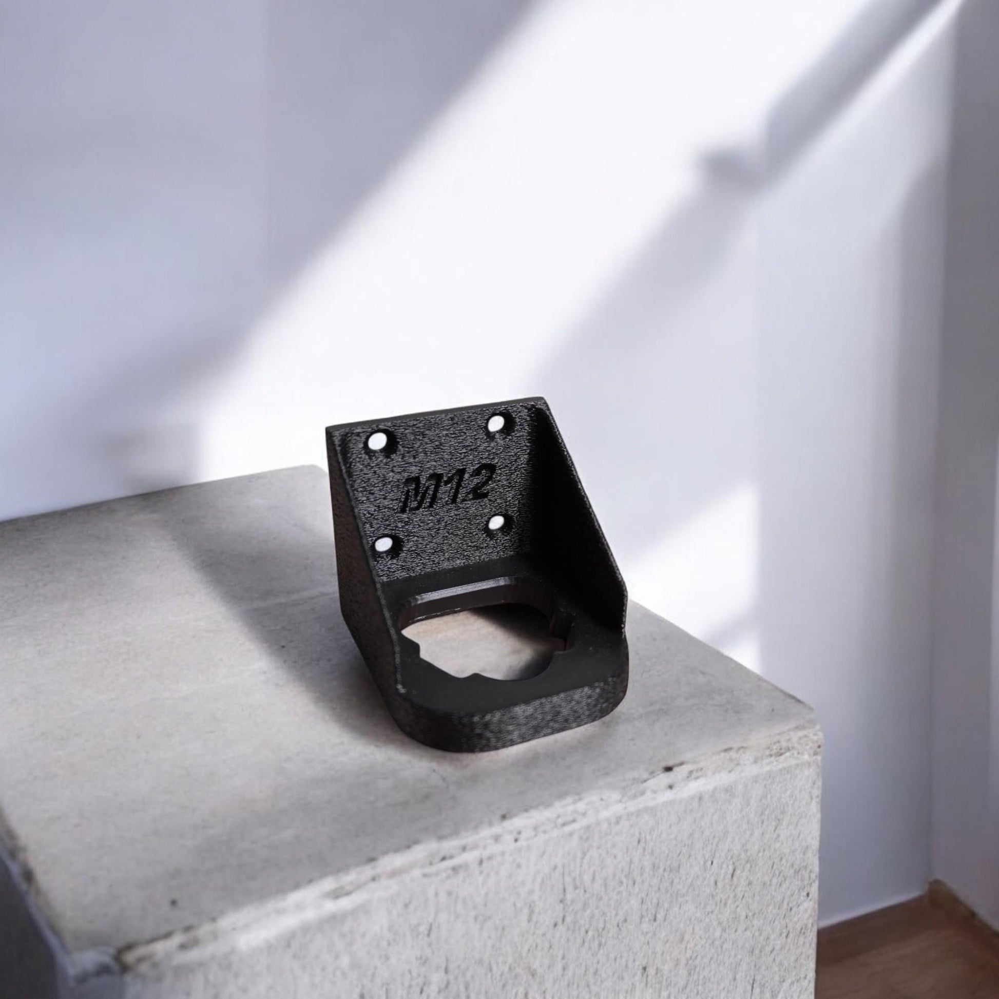 Wall-mounted M12 battery holder made from PETG, featuring multiple slots for securely storing M12 batteries. The holder is mounted on a wall, showcasing its compact and organized design. (etsy image id: 6528013654)