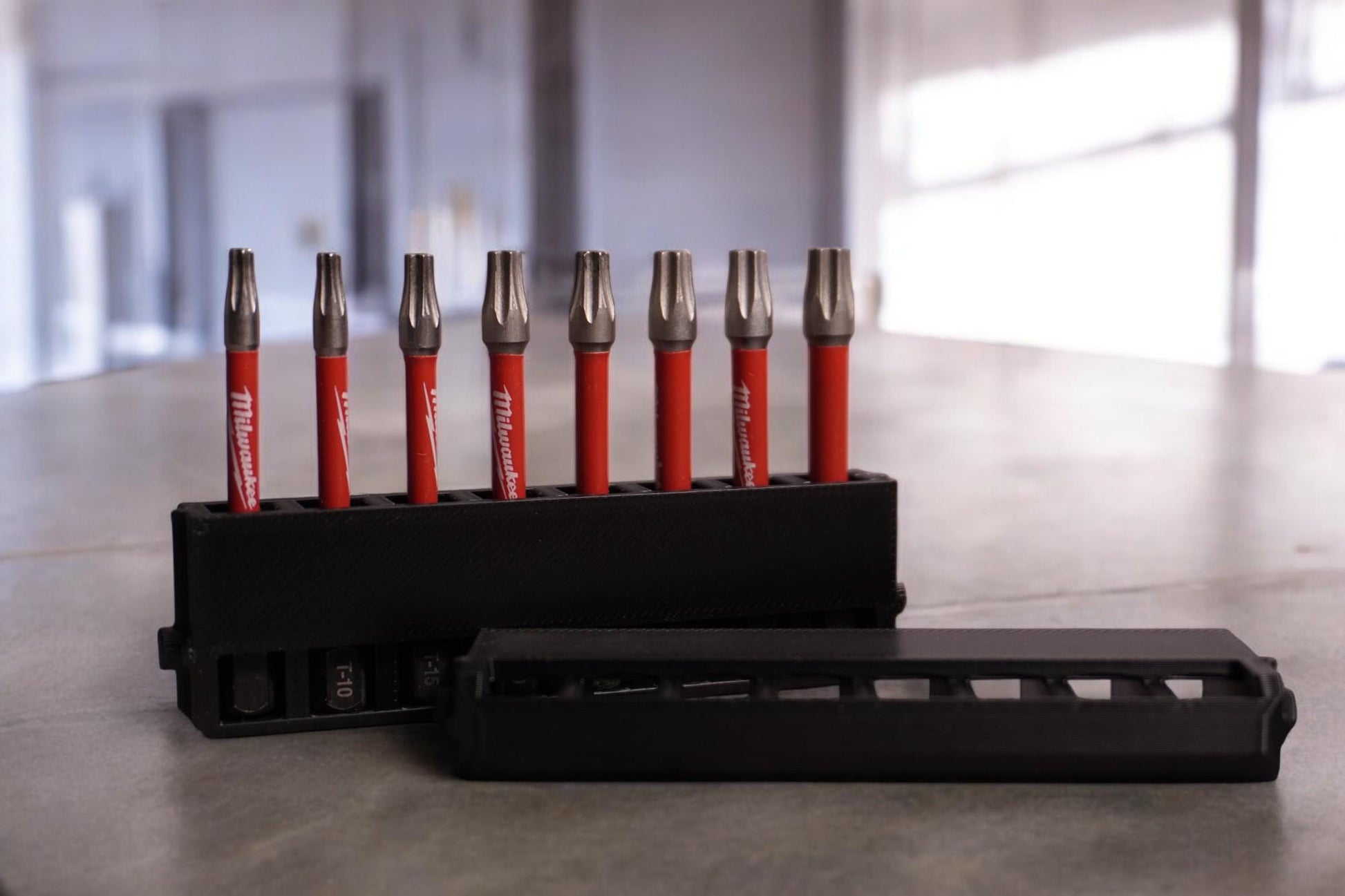 long bit holder with a black design, featuring a secure cover and slots for multiple drill bits. (etsy image id: 6531721880)