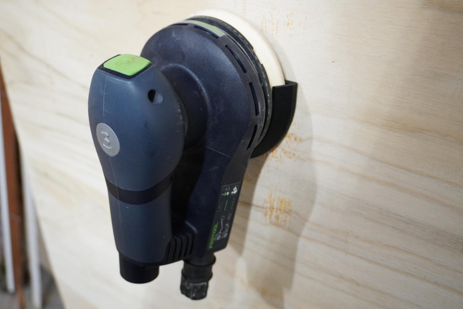 Wall-mounted view of the Festool ETS EC 125/3 holder on a backdrop (etsy image id: 6554064211)