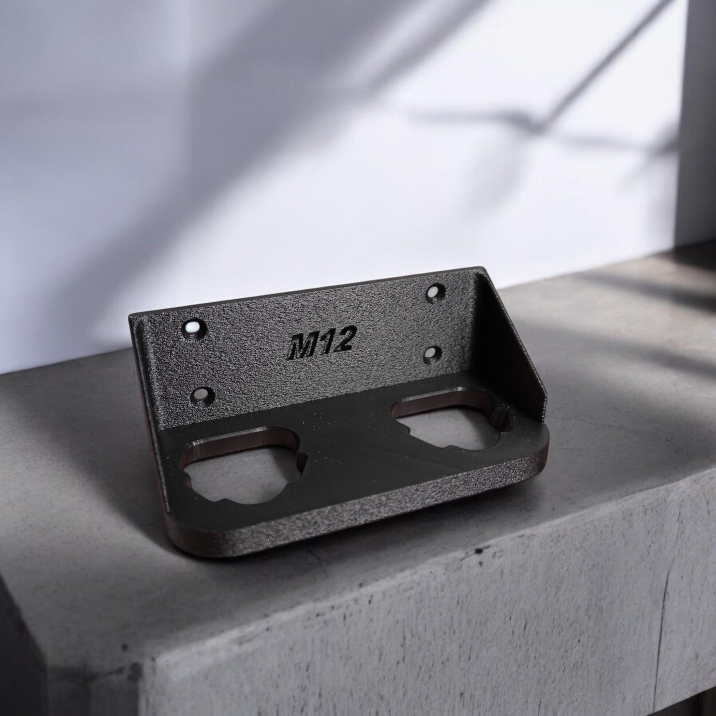 Wall-mounted M12 battery holder made from PETG, featuring multiple slots for securely storing M12 batteries. The holder is mounted on a wall, showcasing its compact and organized design. (etsy image id: 6576133201)