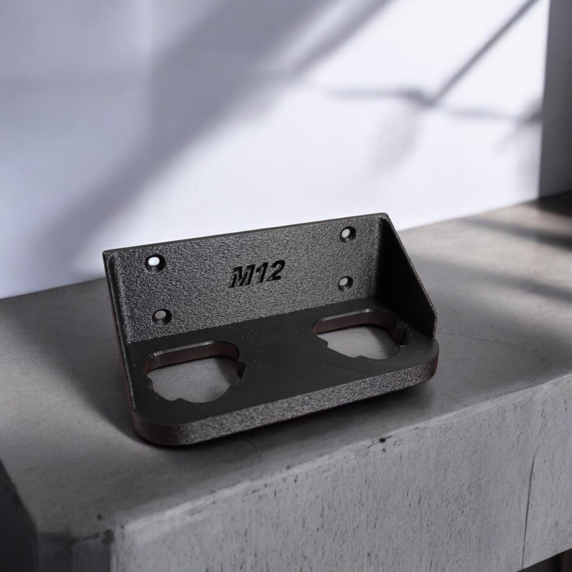Wall-mounted M12 battery holder made from PETG, featuring multiple slots for securely storing M12 batteries. The holder is mounted on a wall, showcasing its compact and organized design. (etsy image id: 6576133201)