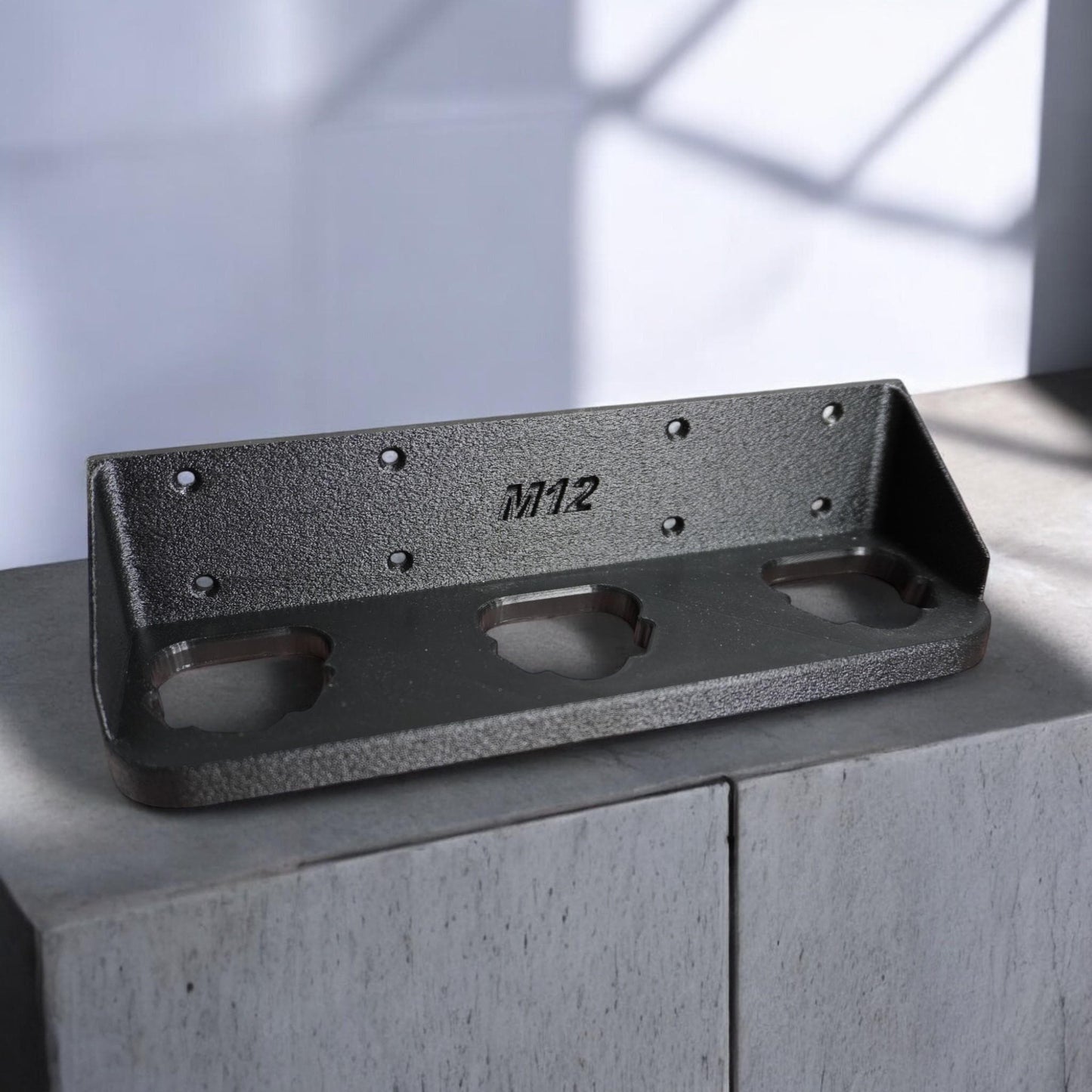 Wall-mounted M12 battery holder made from PETG, featuring multiple slots for securely storing M12 batteries. The holder is mounted on a wall, showcasing its compact and organized design. (etsy image id: 6576133331)