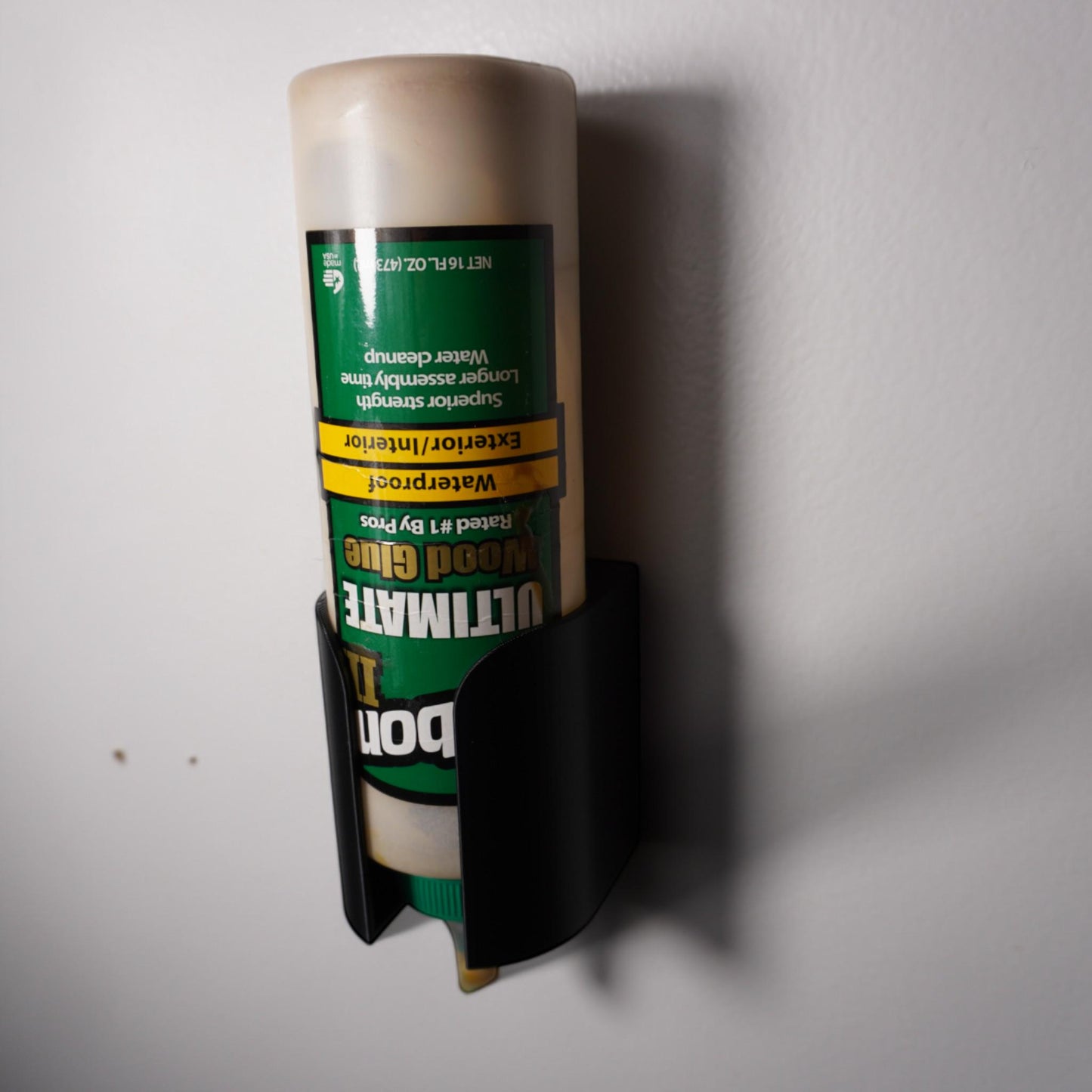 3D-printed glue bottle holder, made from PETG plastic. Designed to securely hold your glue bottle upside-down for smooth flow or upright for stability, it’s perfect for woodworkers (etsy image id: 6577613527)