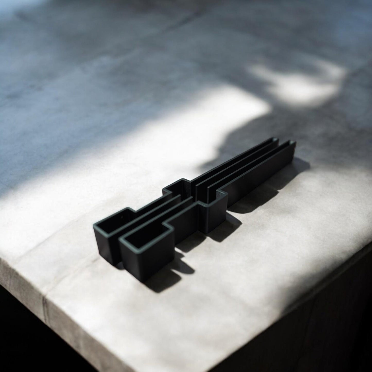 Top view of 3D-printed track rail end cap set on concrete surface (etsy image id: 6580575080)
