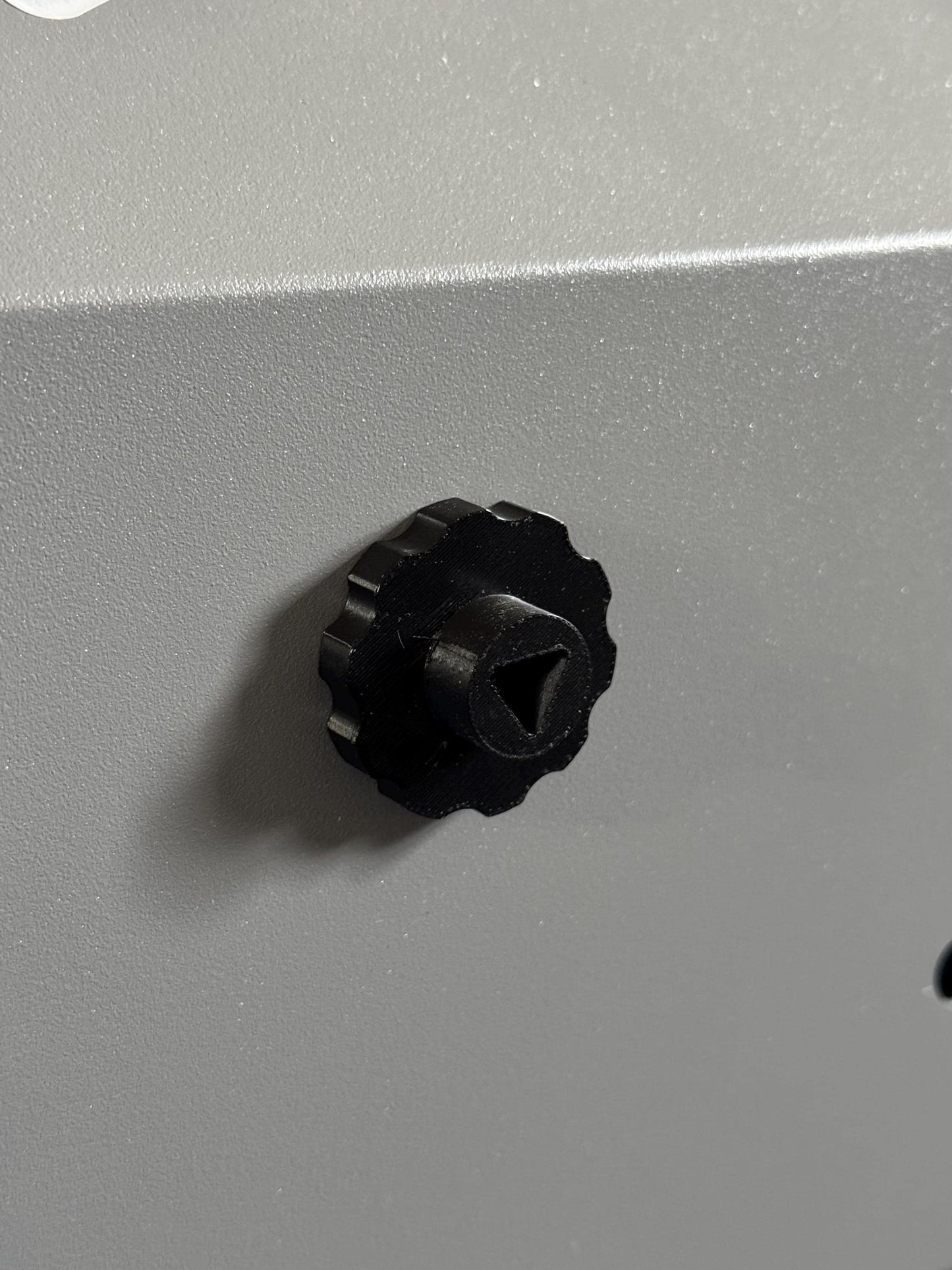Set of 4 black 3D printed magnetic triangle knobs installed on OMTech laser machine for easy access and secure door operation (etsy image id: 6734501332)