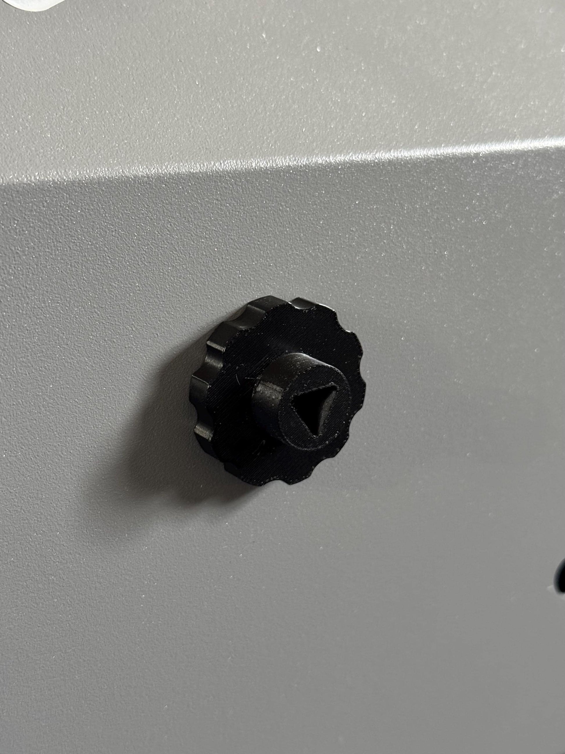 Set of 4 black 3D printed magnetic triangle knobs installed on OMTech laser machine for easy access and secure door operation (etsy image id: 6734501332)