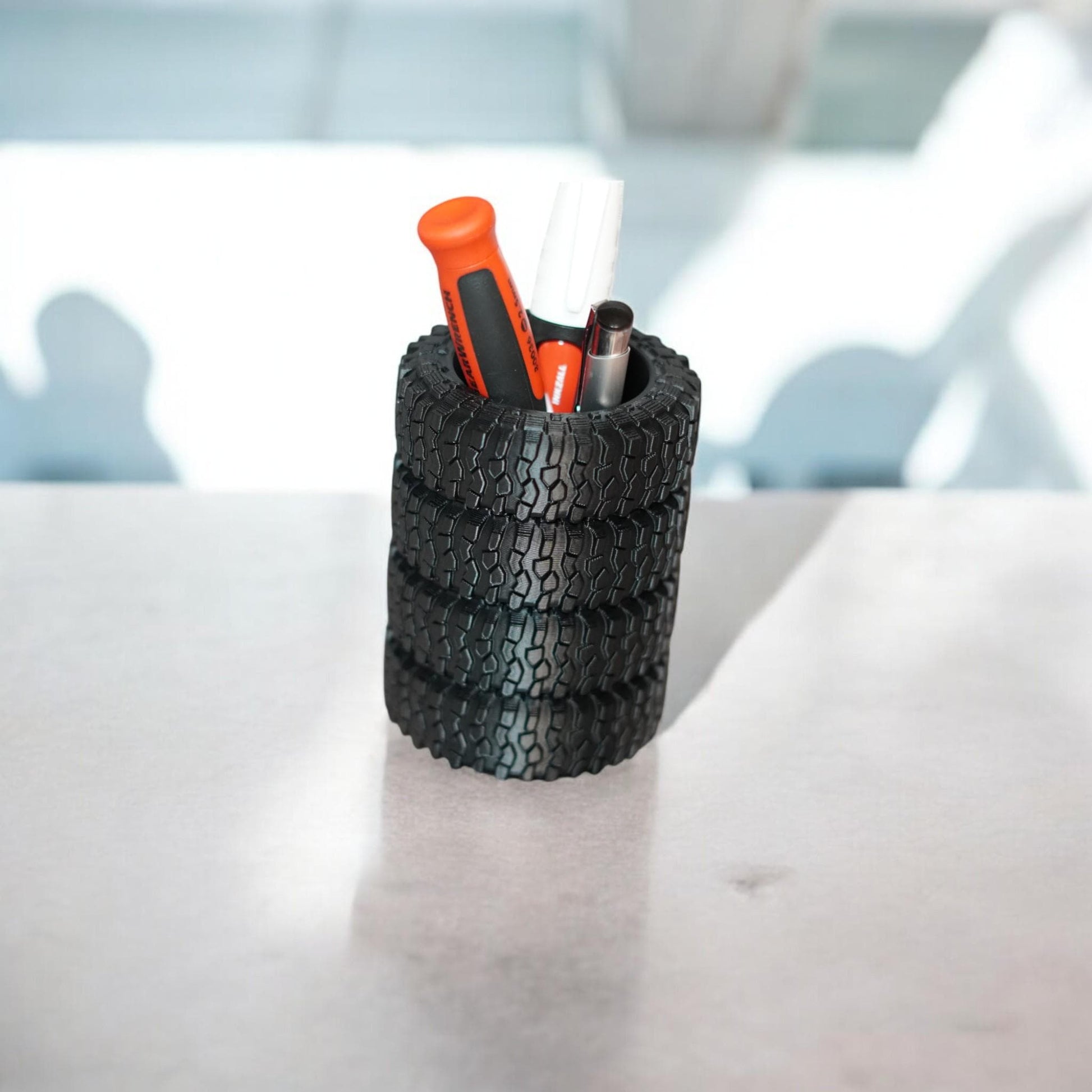 3D printed tire pen holder and business card stand in black, styled with realistic off-road tread details. Perfect desk organizer gift for auto lovers, mechanics, or off-road fans. Made by DigitalTimber. (etsy image id: 6741719758)