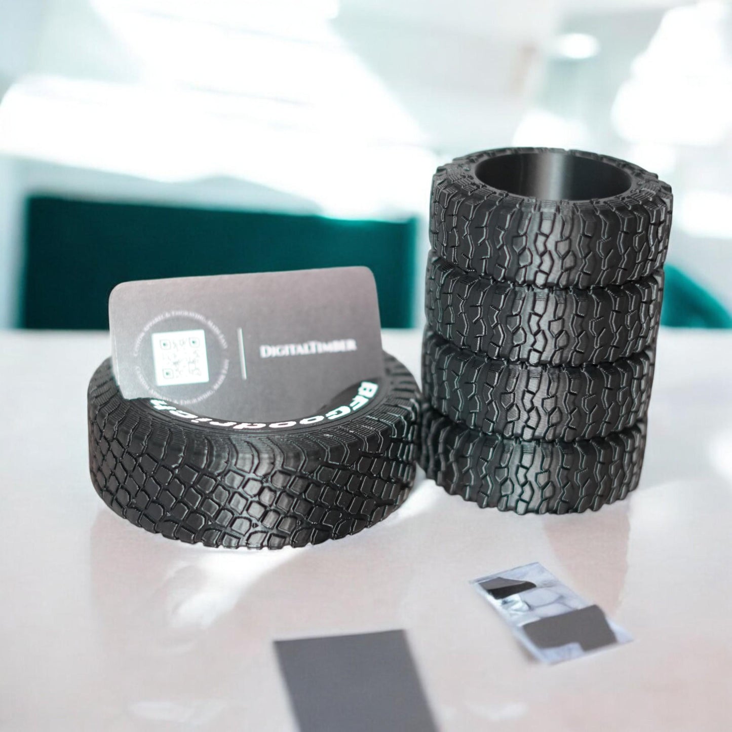 3D printed tire pen holder and business card stand in black, styled with realistic off-road tread details. Perfect desk organizer gift for auto lovers, mechanics, or off-road fans. Made by DigitalTimber. (etsy image id: 6741719764)