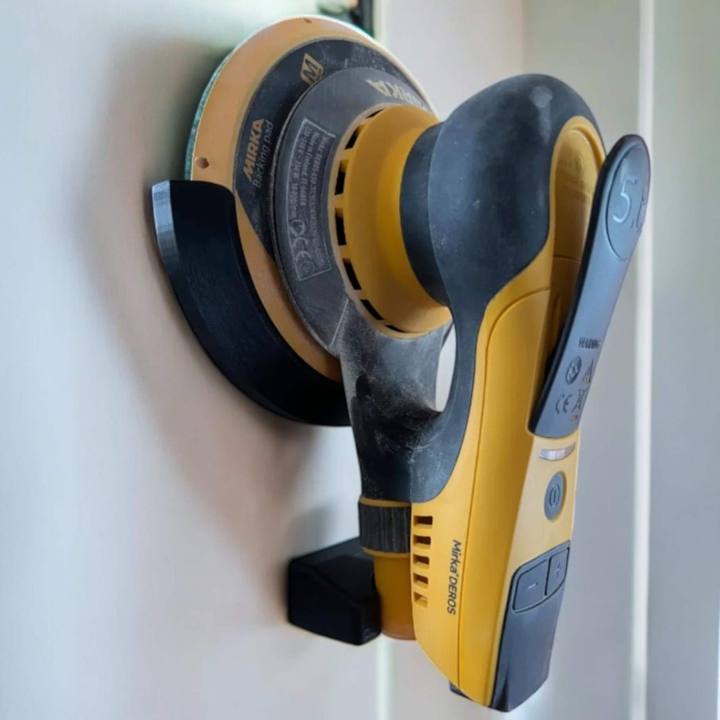 Mirka DEROS sander mounted on wall using custom 3D-printed holder (etsy image id: 6749132914)