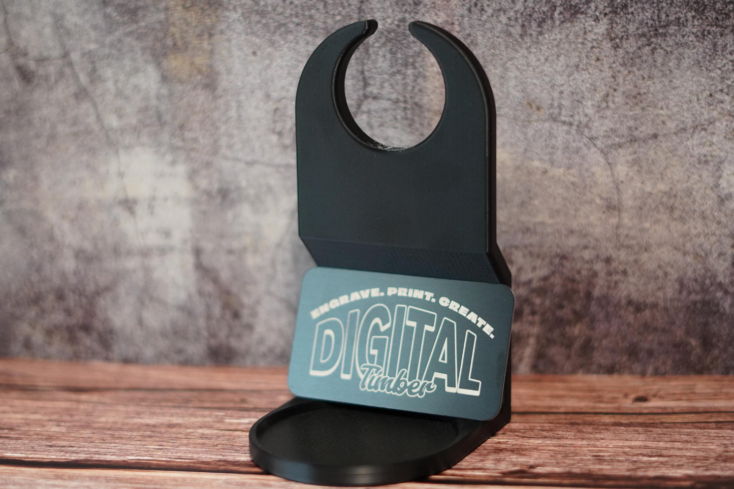 Laundry jug cup holder on wooden surface with teal DigitalTimber logo, showcasing flat back and wide base. (etsy image id: 6784377107)