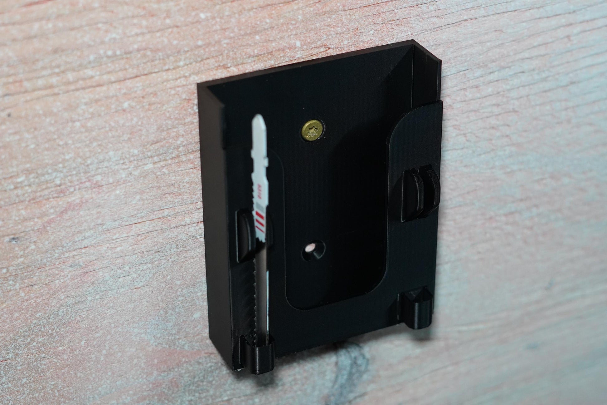 Wall-mounted black jigsaw holder with Milwaukee M18 tool clipped in (etsy image id: 6837625289)