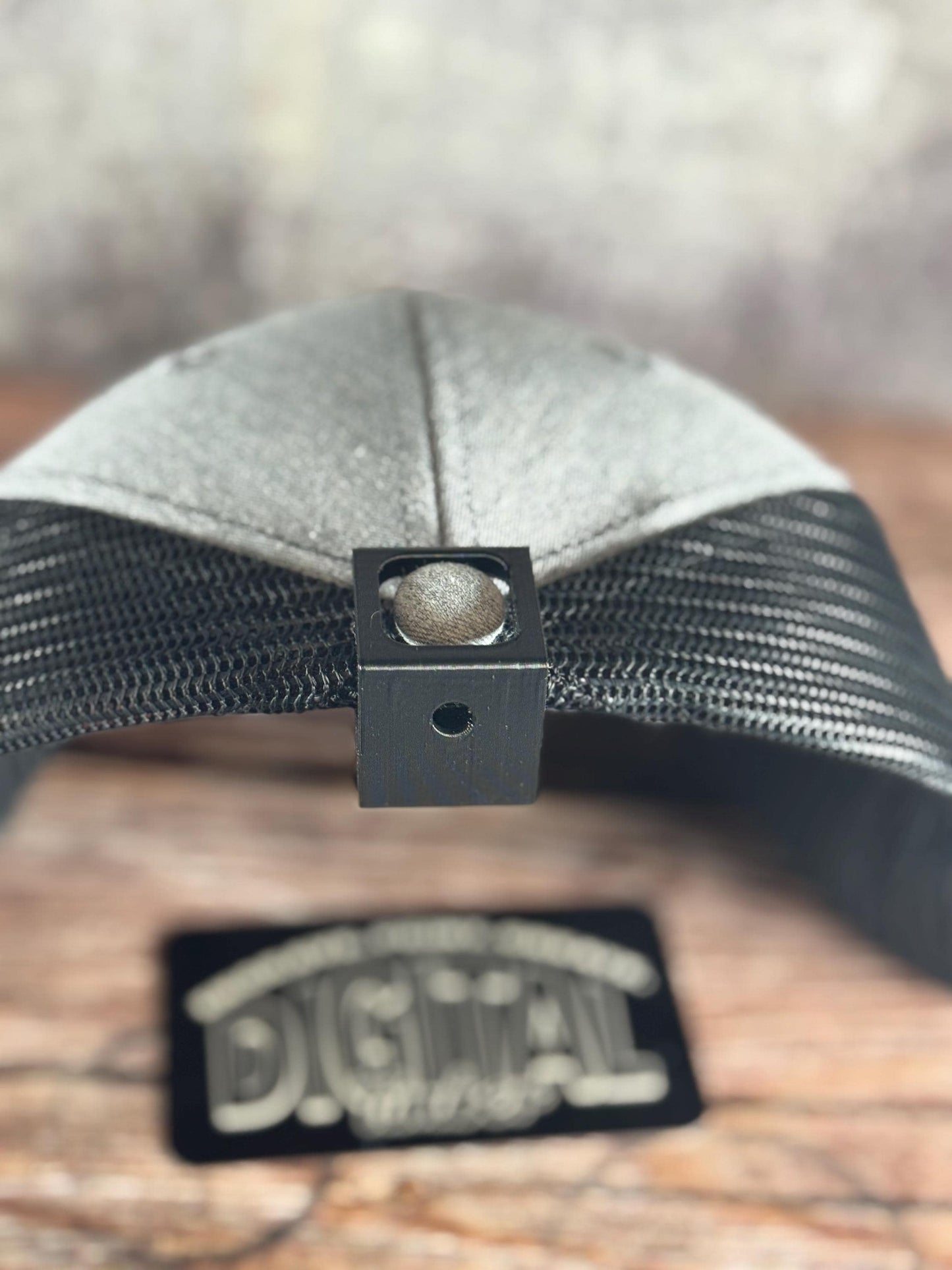 Angled view showing the hook holding a trucker hat (etsy image id: 6918792991)