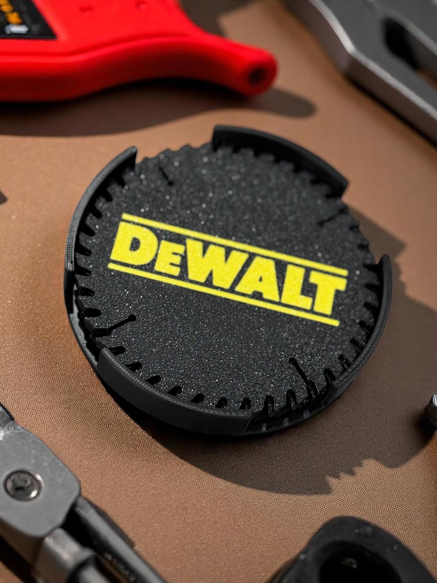 Close-up of DeWalt saw blade coaster resting on table with tools around it (etsy image id: 6983625209)