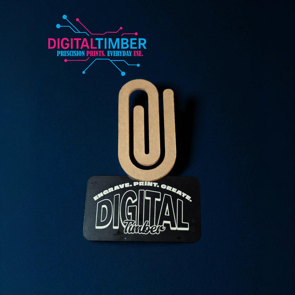 Single jumbo acrylic paper clip leaning on a DigitalTimber card, showing shape and thickness clearly (etsy image id: 7120468205)