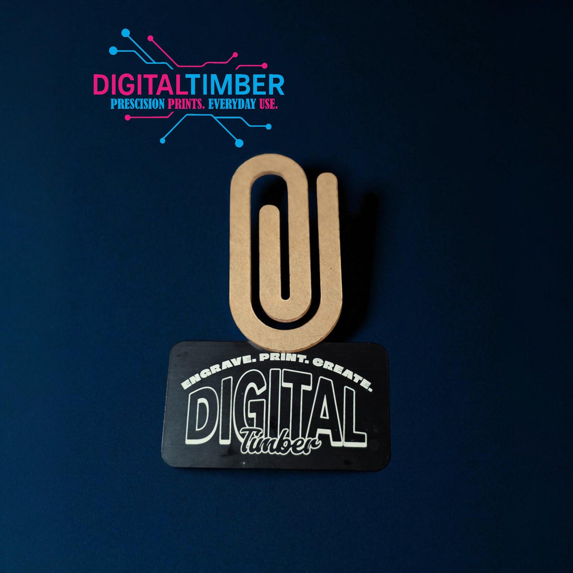 Single jumbo acrylic paper clip leaning on a DigitalTimber card, showing shape and thickness clearly (etsy image id: 7120468205)