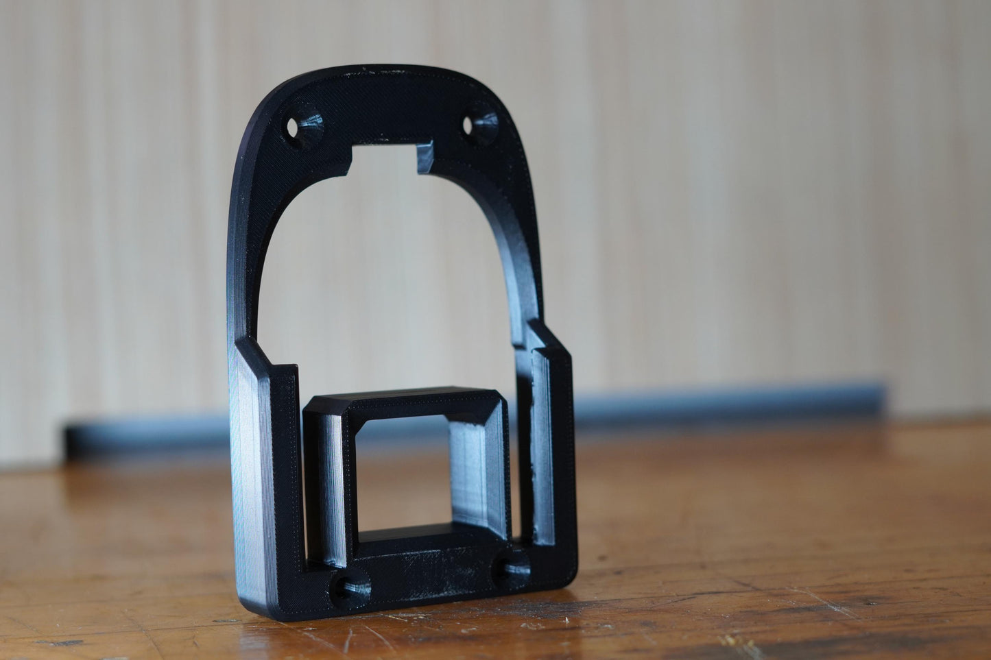 Black 3D printed RIDGID 18V battery mount standing upright on workbench (etsy image id: 7207027439)