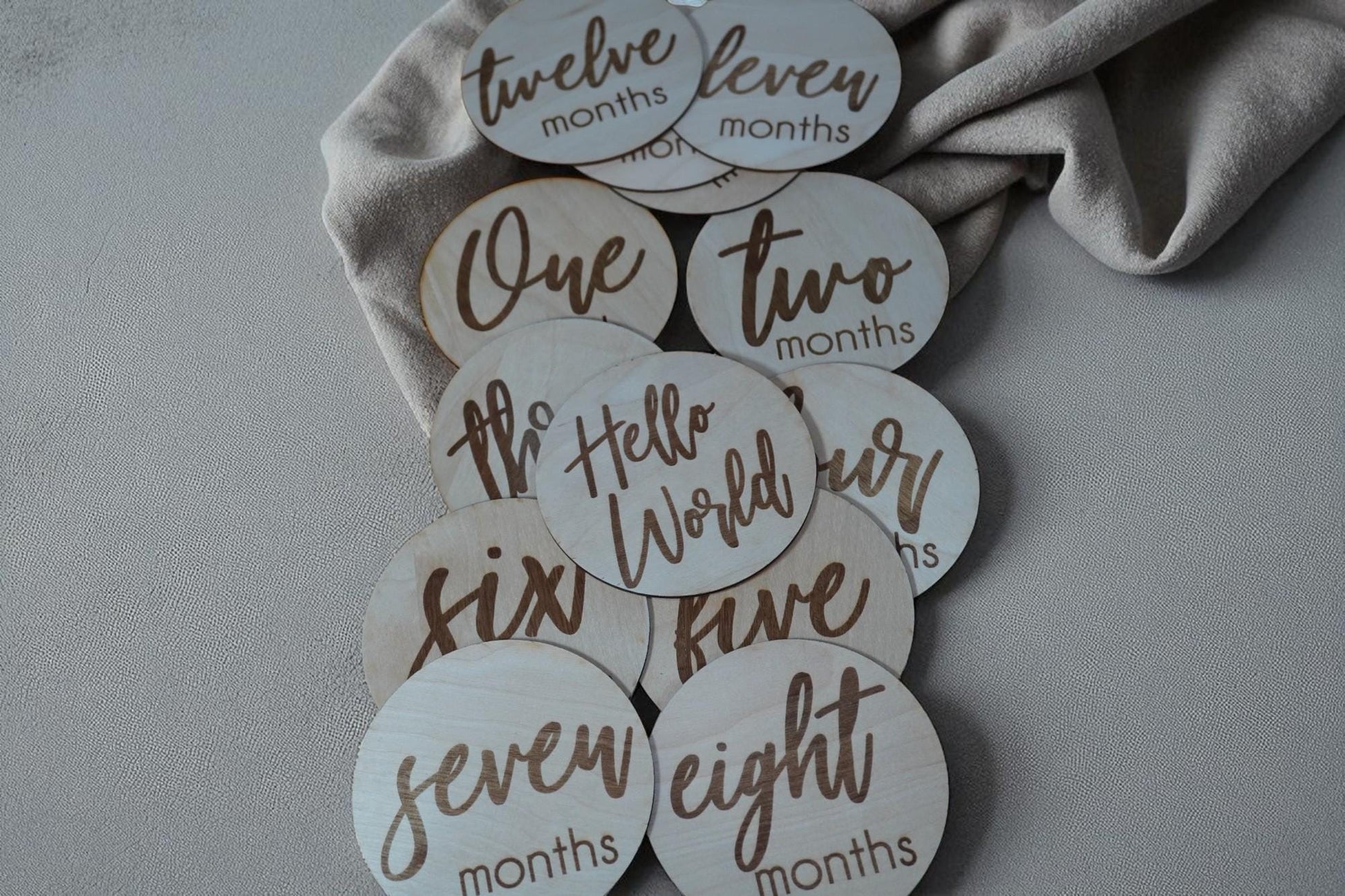 Full set of engraved wooden monthly milestone discs from one to twelve months, baby photo prop collection. (etsy image id: 7212767950)