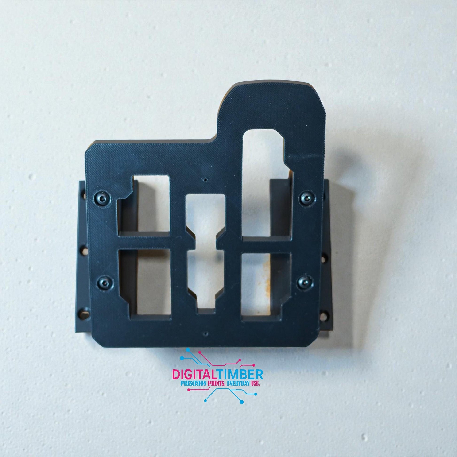 Top-down view of 3D printed Milwaukee charger mount showing screw holes and charger alignment slots (etsy image id: 7442989636)