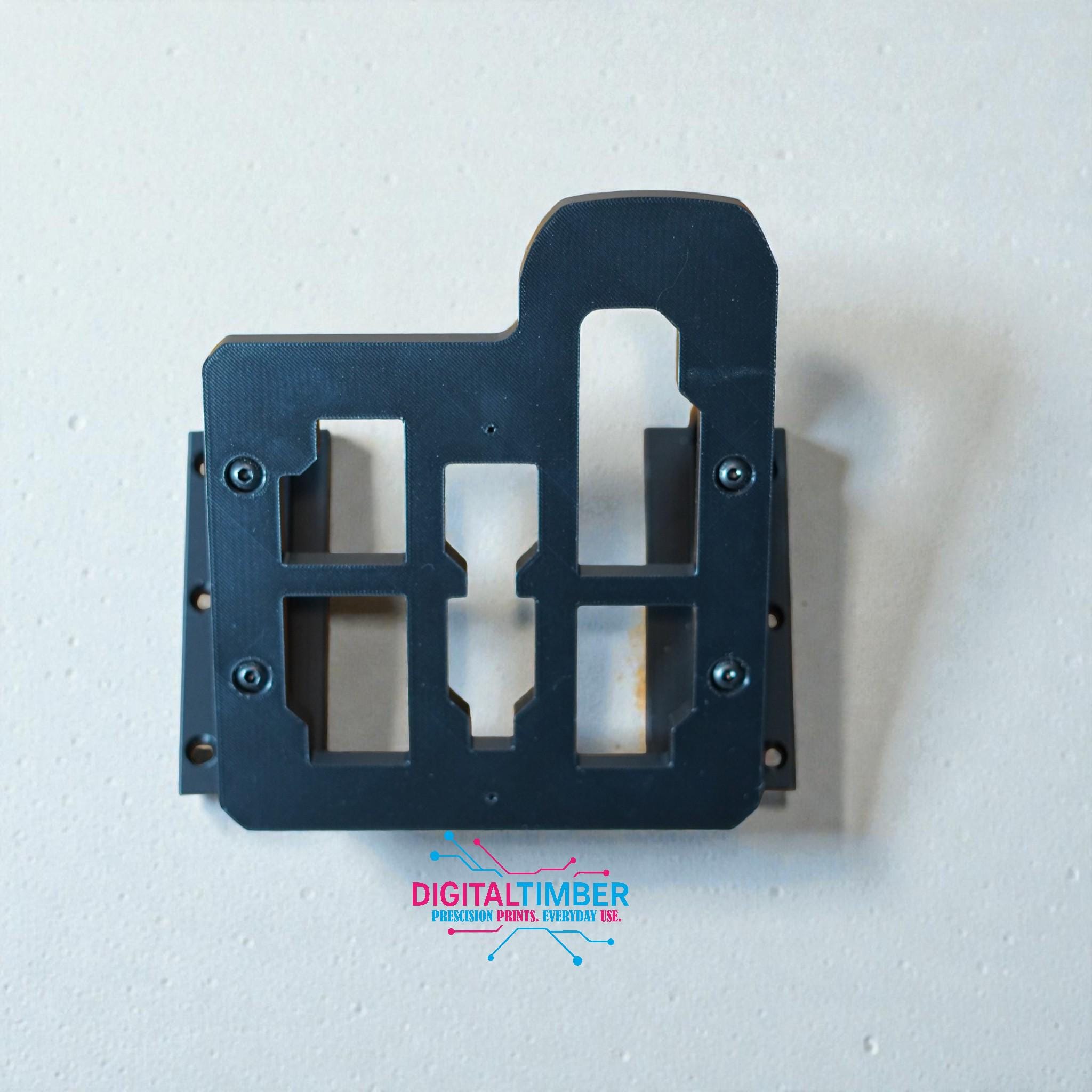 Top-down view of 3D printed Milwaukee charger mount showing screw holes and charger alignment slots (etsy image id: 7442989636)