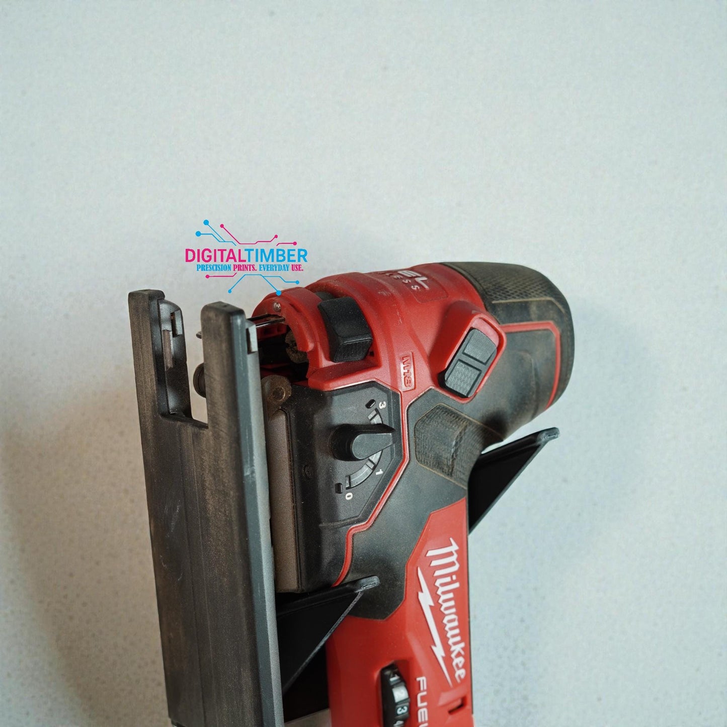 Close-up of Milwaukee jigsaw resting in 3D printed wall holder showing precise angled support arms (etsy image id: 7443002782)
