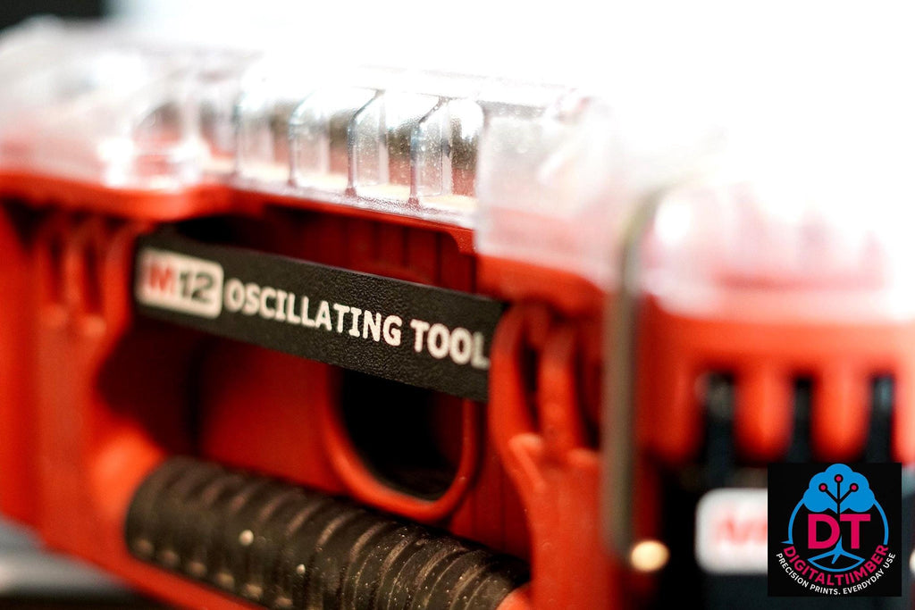 A red Milwaukee Packout box with a clear lid has a black label clip attached, displaying "M12 OSCILLATING TOOL" in white text. __etsy:8313099830