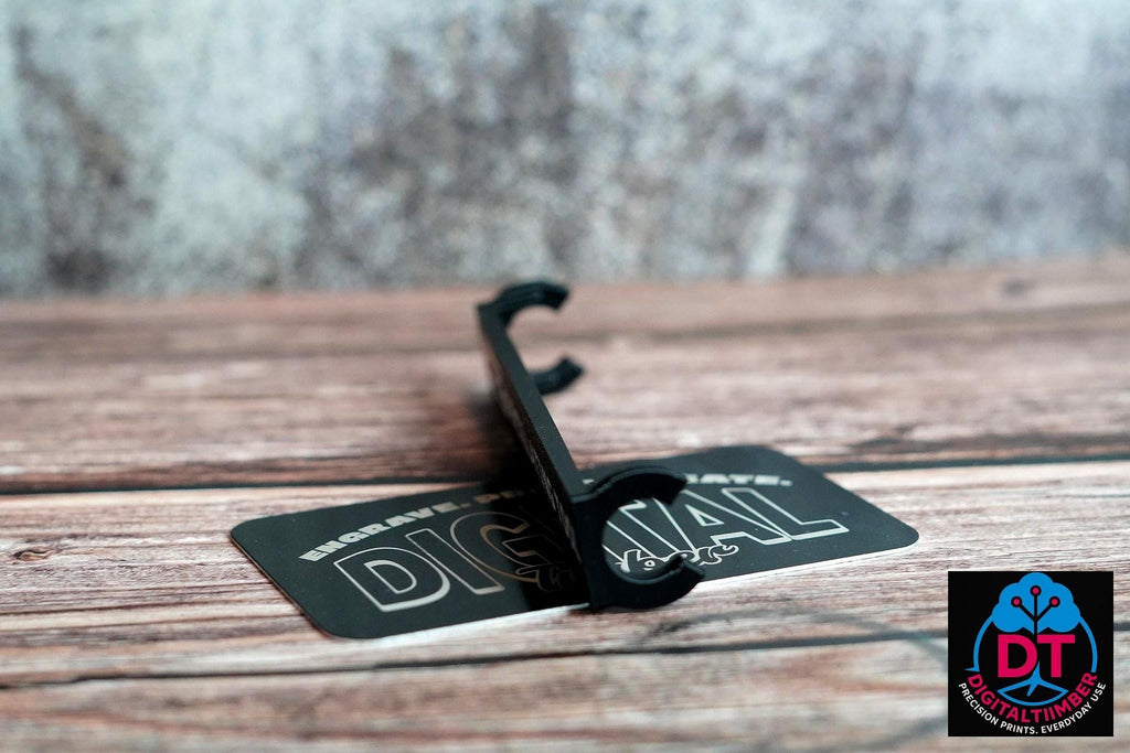 A black plastic label clip stands on a black card that reads "DIGITAL" in white, on a wooden surface. __etsy:8360985633