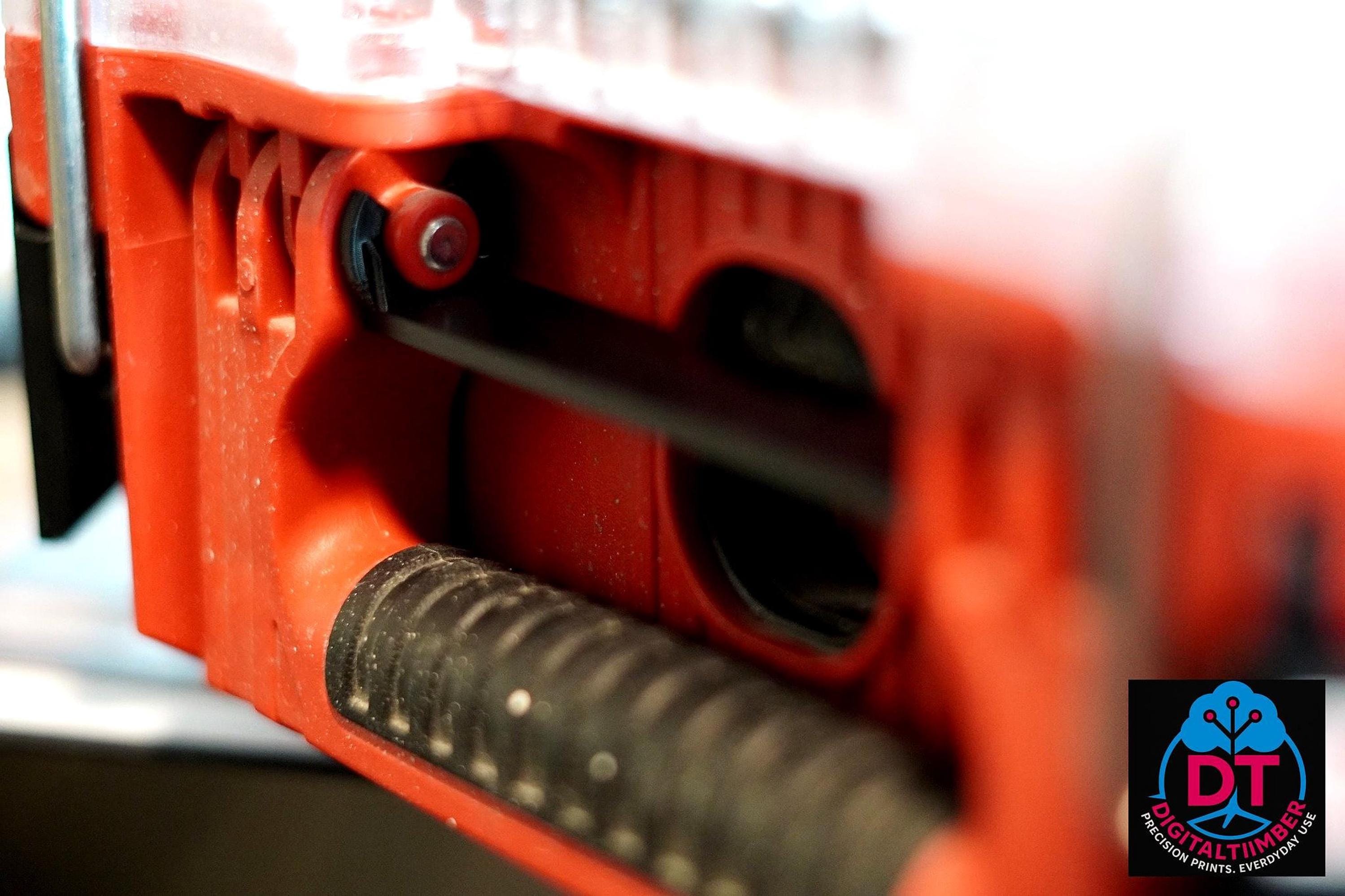 A close-up view inside a red Milwaukee Packout box shows a black rod and textured black rubber, with a red plastic interior. __etsy:8360985733