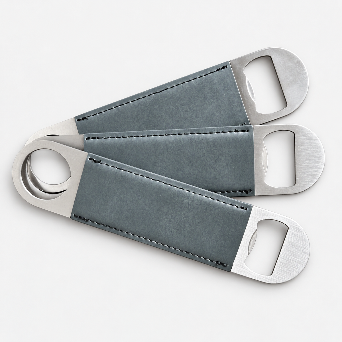 Charcoal leatherette bottle openers before custom UV printing, light gray background