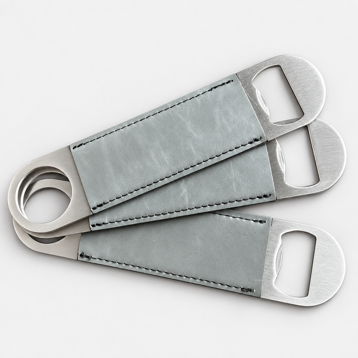 Flint leatherette bottle openers before custom UV printing, light gray background