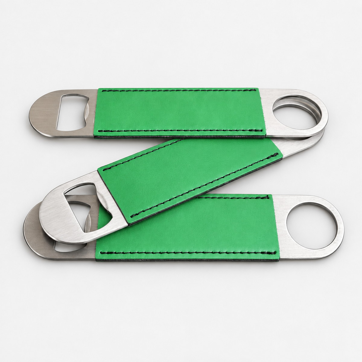 Kelly Green leatherette bottle openers before custom UV printing, light gray background